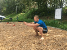 Franky führt die Calisthenics Übung "Kniebeuge" aus.